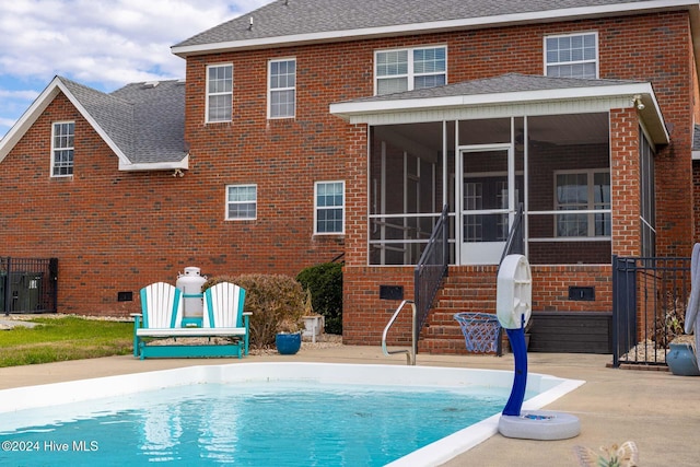 back of house featuring a sunroom and a patio area