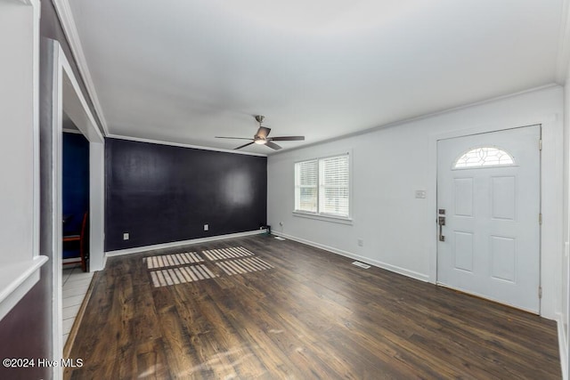 entrance foyer featuring dark hardwood / wood-style flooring, ceiling fan, and ornamental molding