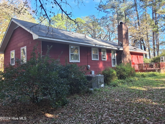 view of side of home featuring central AC unit and a deck