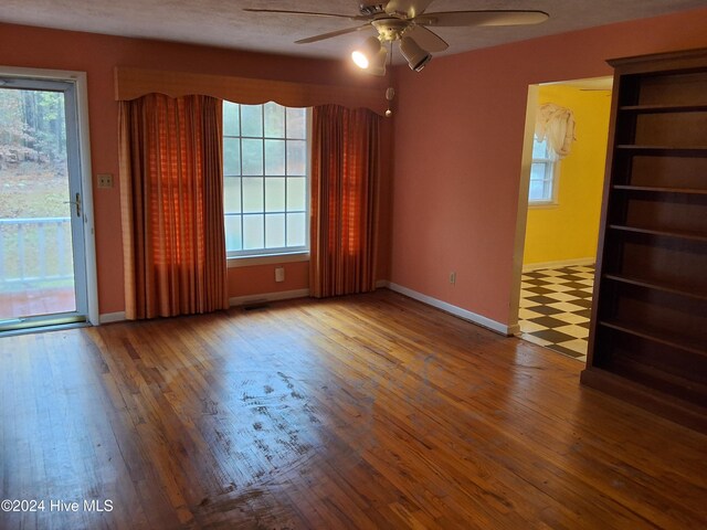 spare room with a textured ceiling, hardwood / wood-style flooring, and ceiling fan