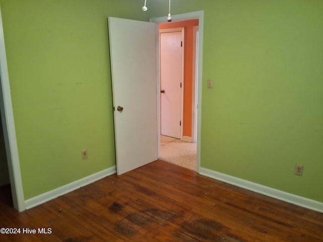 unfurnished room featuring dark hardwood / wood-style floors