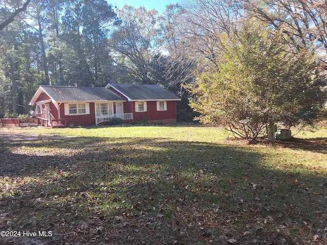 view of front of home with covered porch and a front lawn