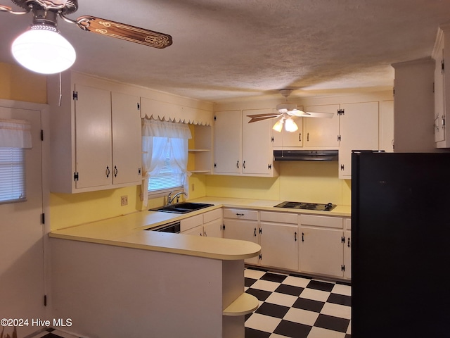 kitchen featuring sink, kitchen peninsula, a textured ceiling, white cabinets, and black appliances