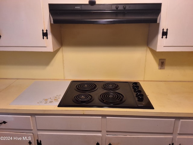 details featuring white cabinets and black electric cooktop