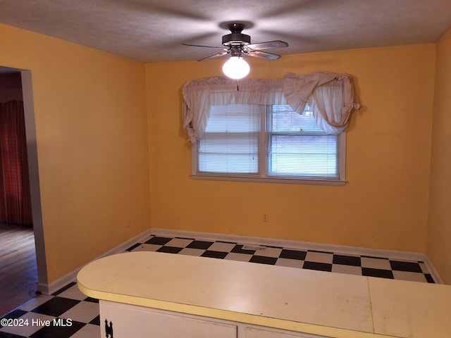 unfurnished dining area featuring ceiling fan