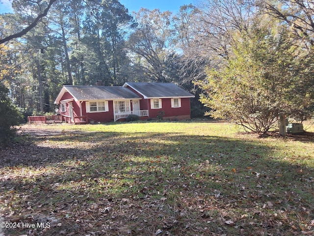 single story home with a front yard and a porch