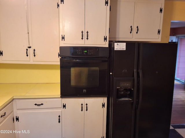 kitchen featuring white cabinetry and black appliances