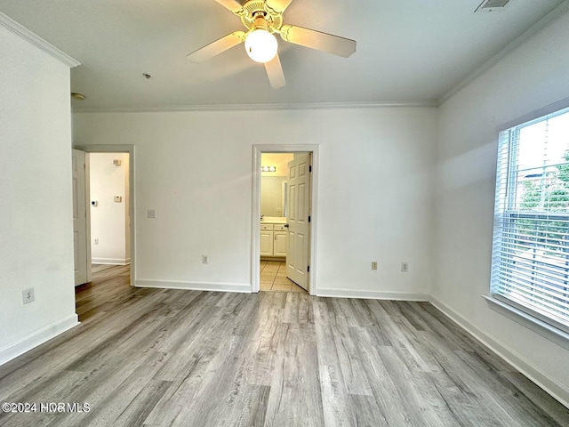 unfurnished bedroom with ceiling fan, light hardwood / wood-style floors, crown molding, and ensuite bath