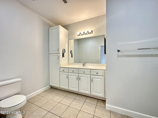 bathroom featuring tile patterned flooring, vanity, and toilet