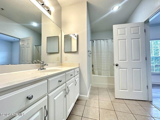 bathroom with tile patterned flooring, vanity, and shower / tub combo