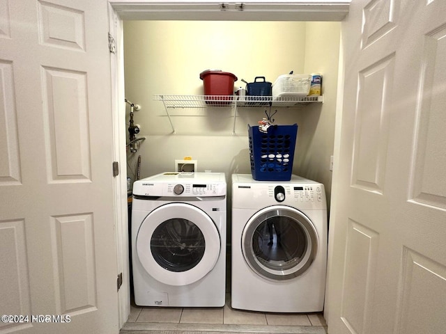 laundry area with light tile patterned flooring and separate washer and dryer