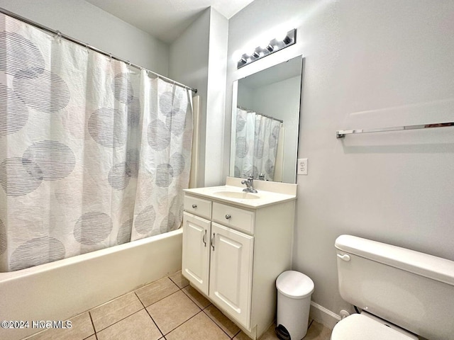 bathroom featuring tile patterned flooring, vanity, and toilet