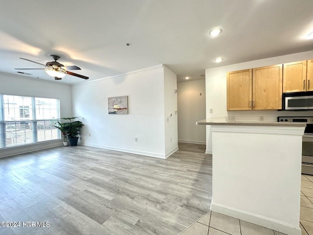 kitchen with light brown cabinets, light wood-type flooring, ornamental molding, and appliances with stainless steel finishes