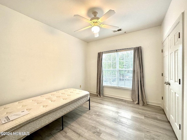 bedroom with ceiling fan and light hardwood / wood-style flooring