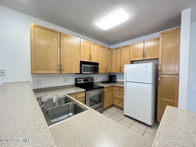 kitchen with appliances with stainless steel finishes, light brown cabinets, light tile patterned floors, and sink