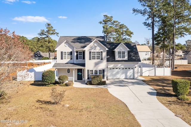 front facade featuring a garage and a front yard