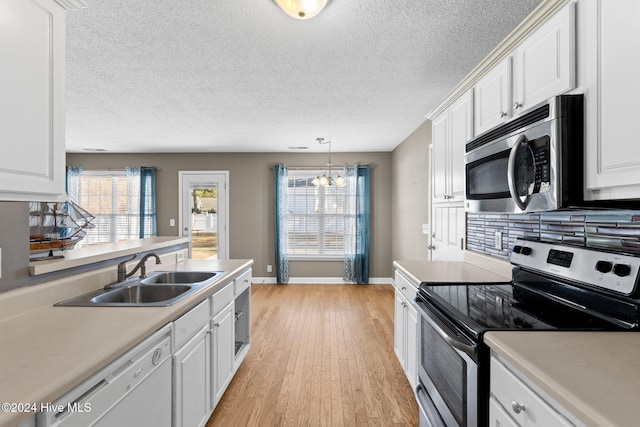 kitchen with sink, white cabinets, and appliances with stainless steel finishes