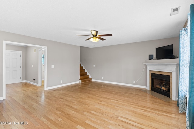 unfurnished living room with ceiling fan and light hardwood / wood-style floors