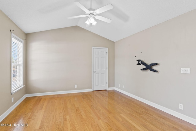 spare room with ceiling fan, wood-type flooring, and lofted ceiling