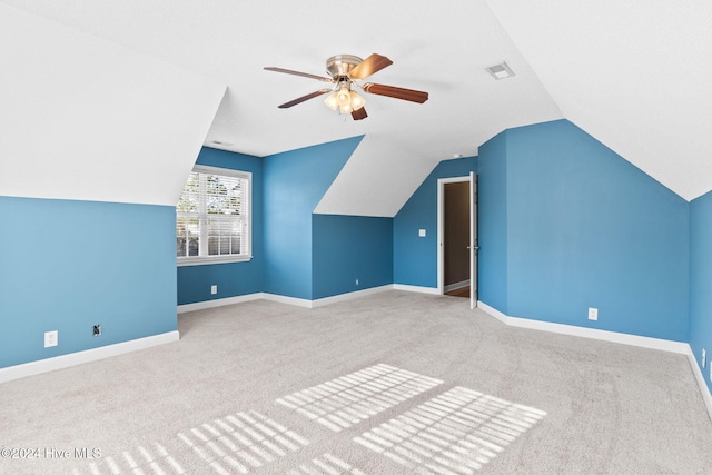 additional living space featuring ceiling fan, carpet, and lofted ceiling