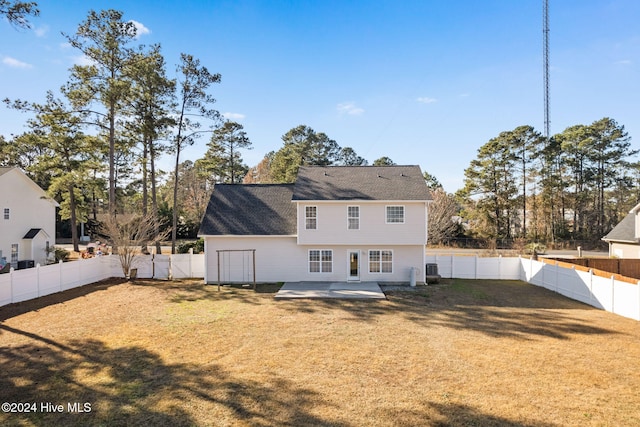 rear view of property with a yard and a patio