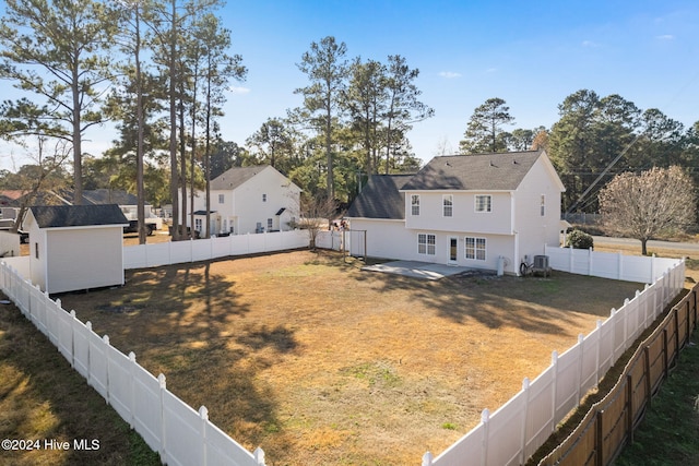 view of yard featuring a storage unit, a patio area, and central air condition unit