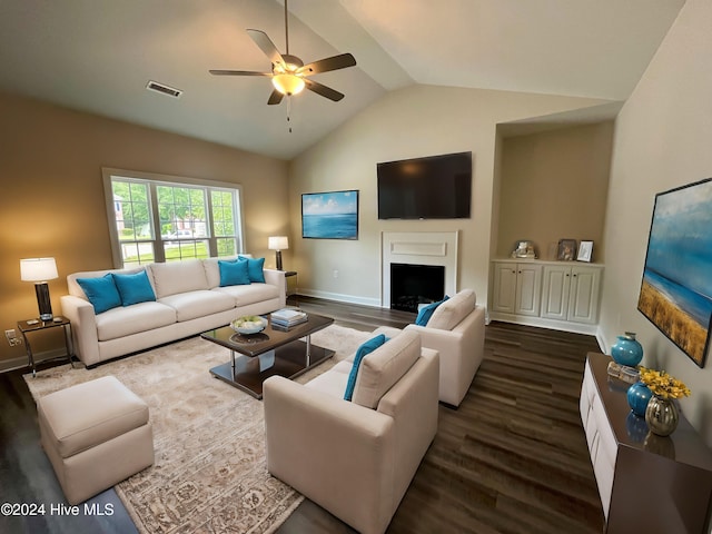 living room with lofted ceiling, ceiling fan, and dark wood-type flooring