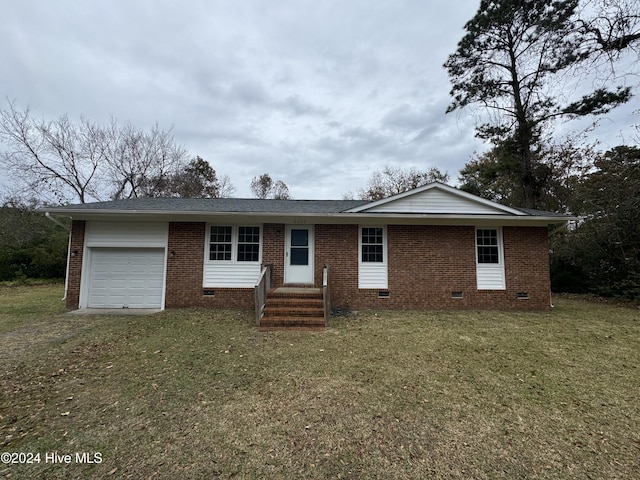 single story home featuring a front lawn and a garage