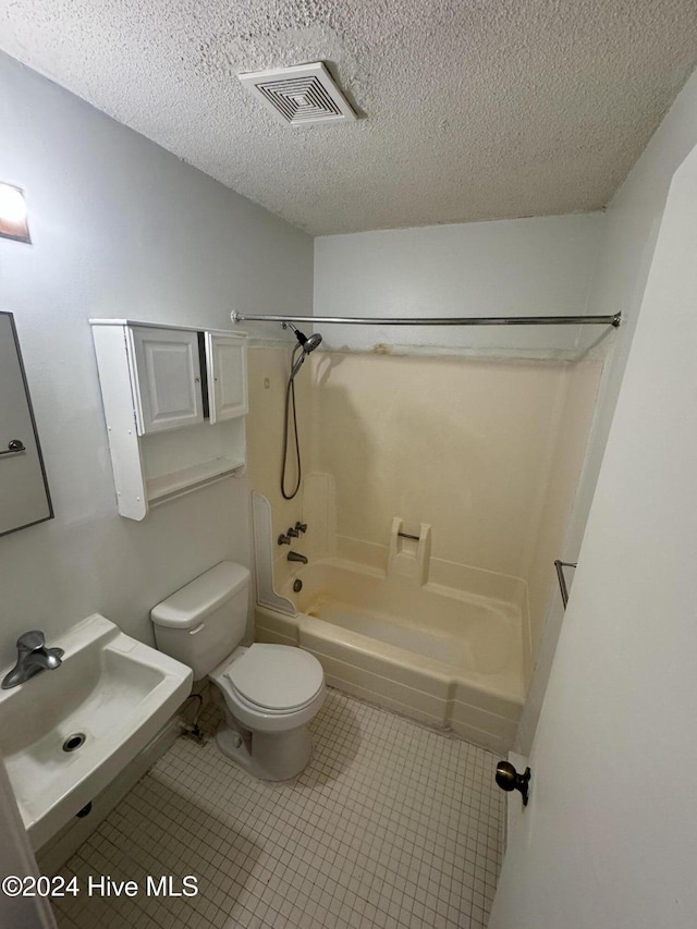 full bathroom featuring sink, shower / bathtub combination, a textured ceiling, and toilet