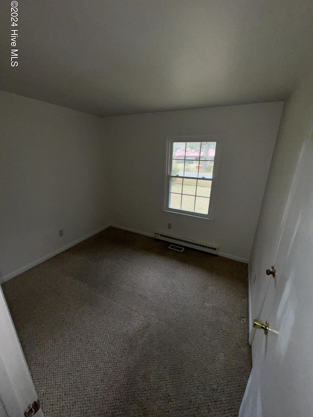 carpeted empty room with a baseboard radiator