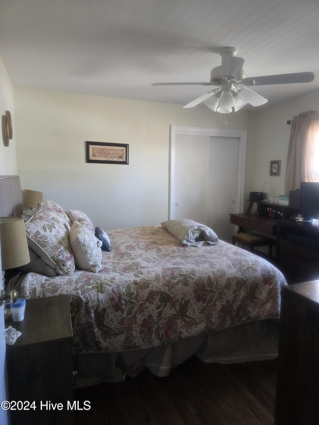 bedroom featuring hardwood / wood-style flooring, ceiling fan, and a closet