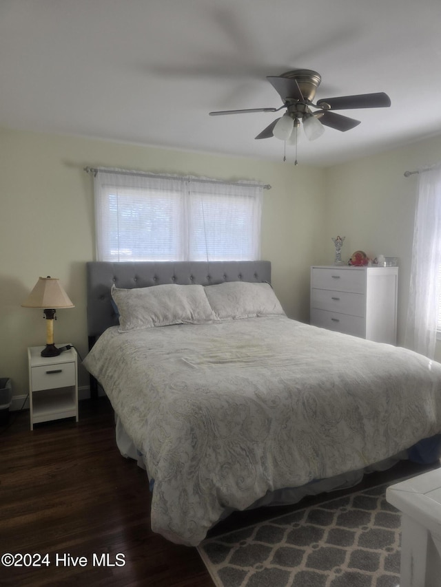 bedroom with ceiling fan and dark hardwood / wood-style floors