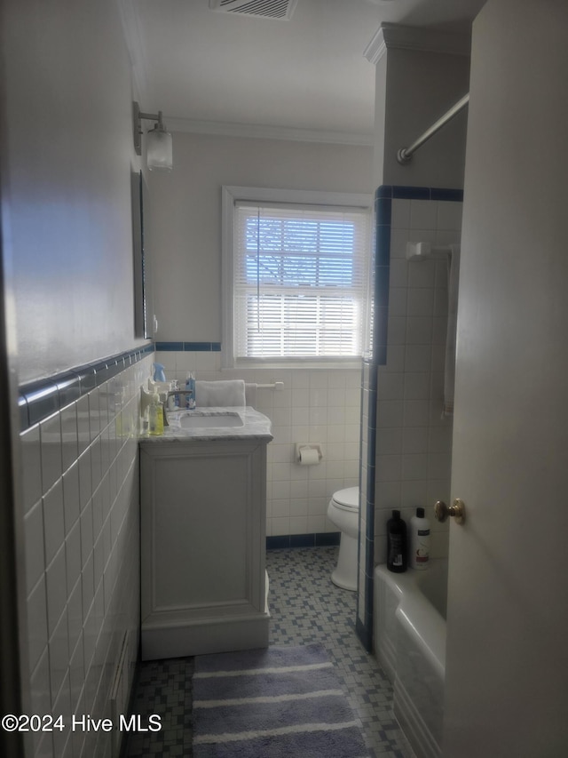 full bathroom with vanity, bathtub / shower combination, toilet, ornamental molding, and tile walls