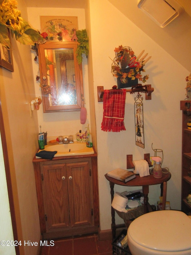 bathroom featuring tile patterned floors, vanity, and toilet