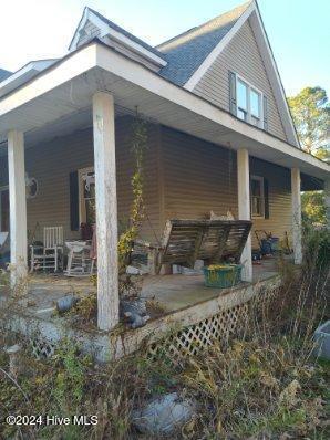 view of property exterior featuring a porch