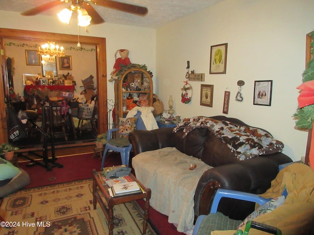 carpeted living room with ceiling fan with notable chandelier and a textured ceiling