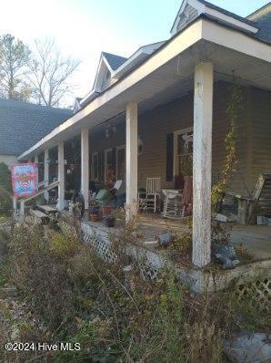 view of side of home with a porch