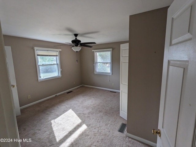 unfurnished bedroom featuring light colored carpet and ceiling fan