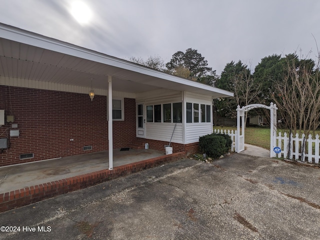 view of side of property featuring a carport