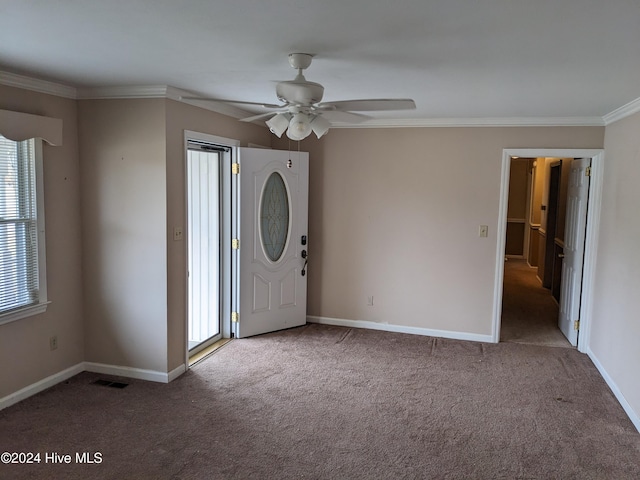 entrance foyer featuring carpet flooring, ceiling fan, and crown molding