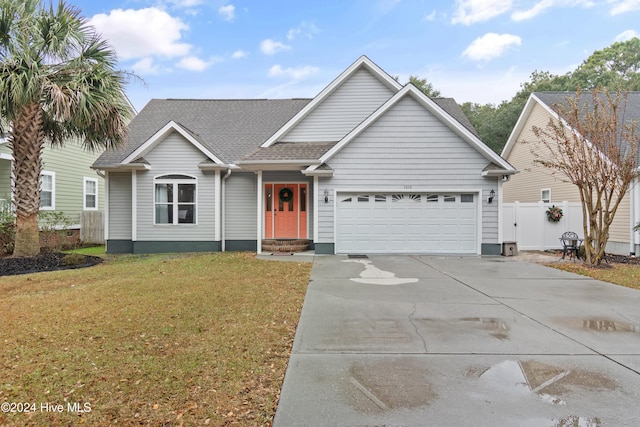 view of front of house with a garage and a front lawn