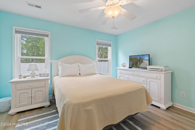 bedroom with ceiling fan and light wood-type flooring