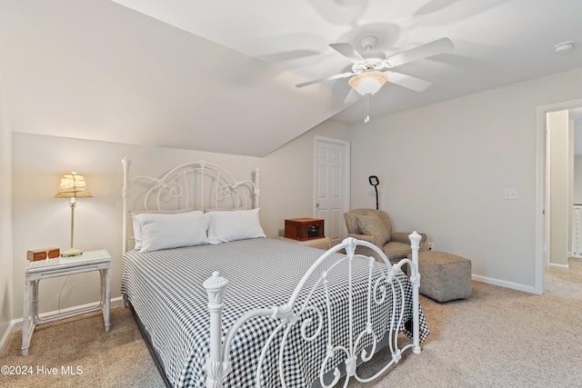 bedroom featuring ceiling fan, carpet floors, and vaulted ceiling