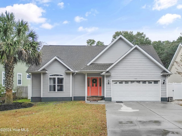 view of front of house featuring a front lawn and a garage