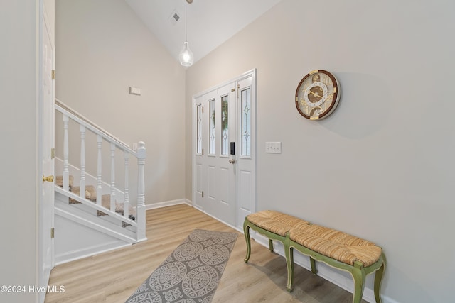 entryway featuring vaulted ceiling and light wood-type flooring