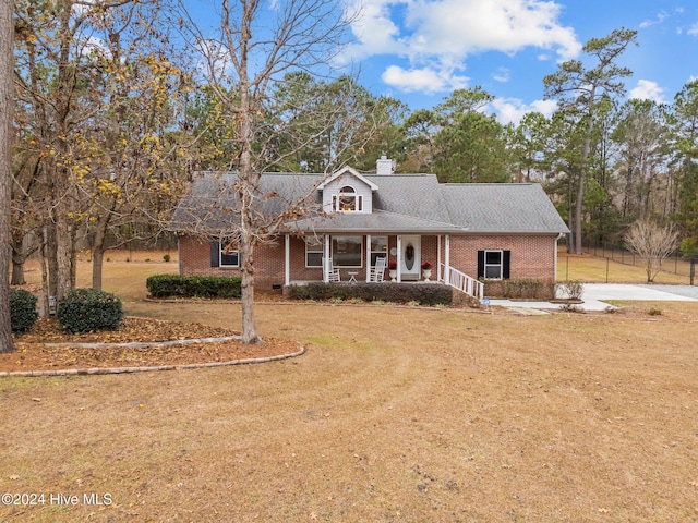 view of front of home with a porch and a front yard