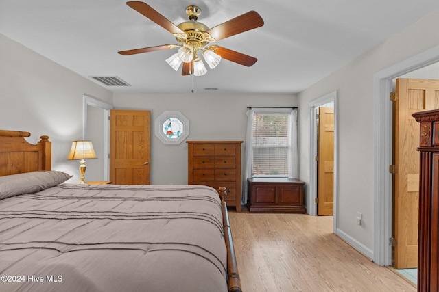 bedroom with ceiling fan and light hardwood / wood-style flooring