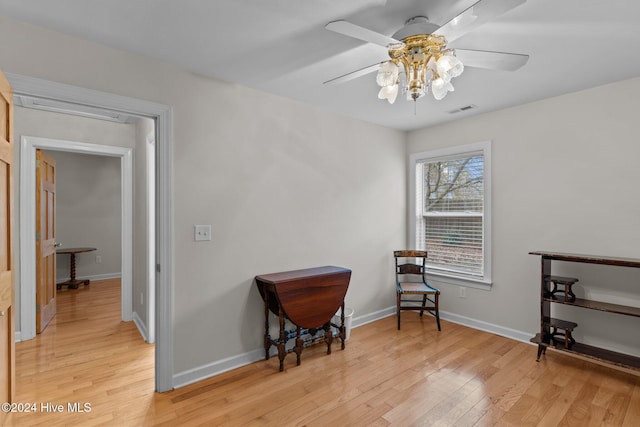 sitting room featuring light wood-type flooring and ceiling fan