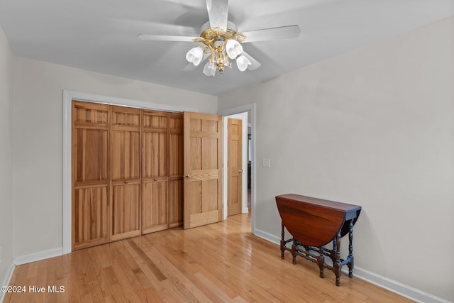 bedroom with a closet, ceiling fan, and light hardwood / wood-style floors