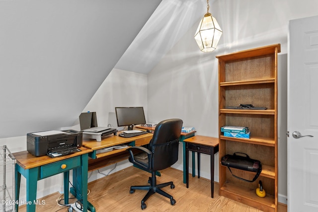 home office featuring wood-type flooring and lofted ceiling